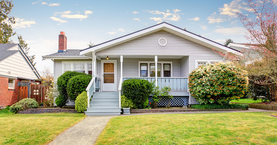 house with green lawn and blue sky being considered as a real estate investment