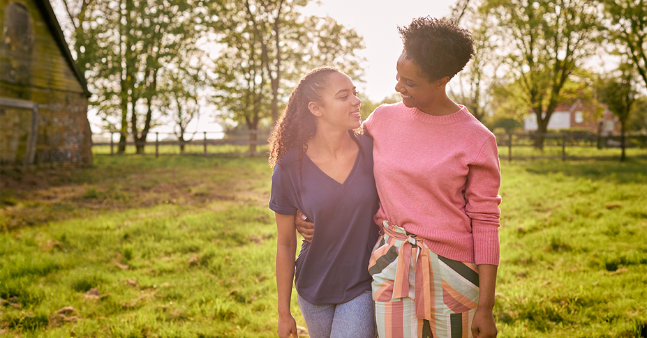 mother and daughter talking outdoors about ira inheritance and beneficiaries